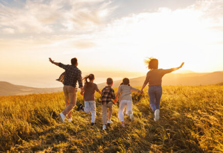 Happy large family: mother, father, children son and daughters on sunset