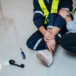 An engineer requests help following a team member's leg injury during electrical work.